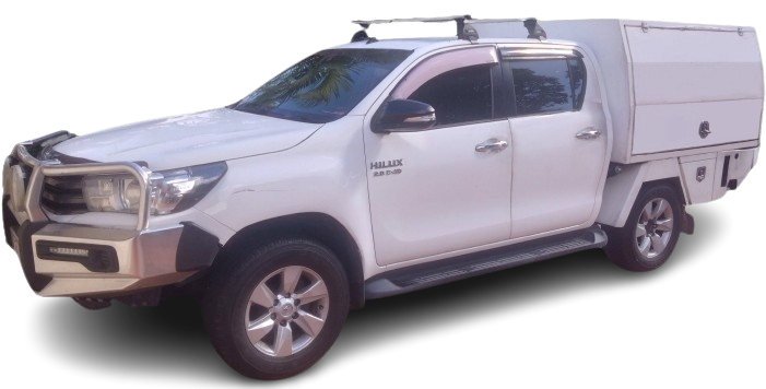 This is a snowmobileair service vehicle, Toyota Hilux with a canopy and roof racks